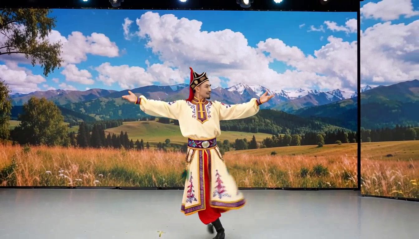 A validation sample generated by FastH3: a performer in an embroidered traditional Kazakh shapan and pointed hat dances with arms outstretched on a studio floor, in front of a large LED backdrop showing steppe grassland, rolling hills, and a blue sky with clouds.